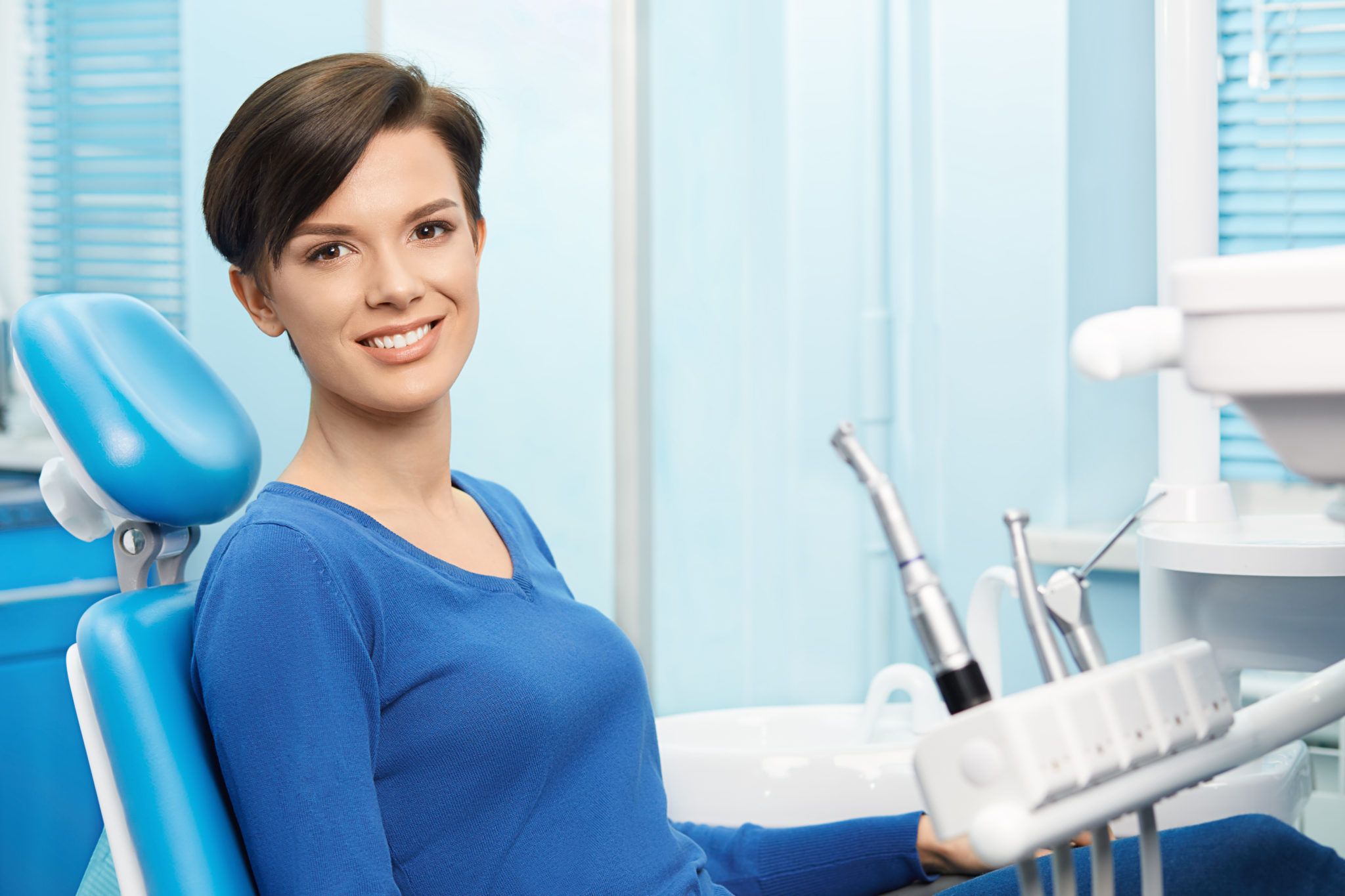 Smiling woman in dentist's chair