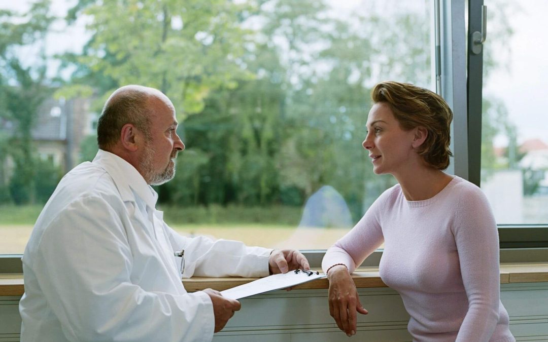 Male doctor meeting with female patient