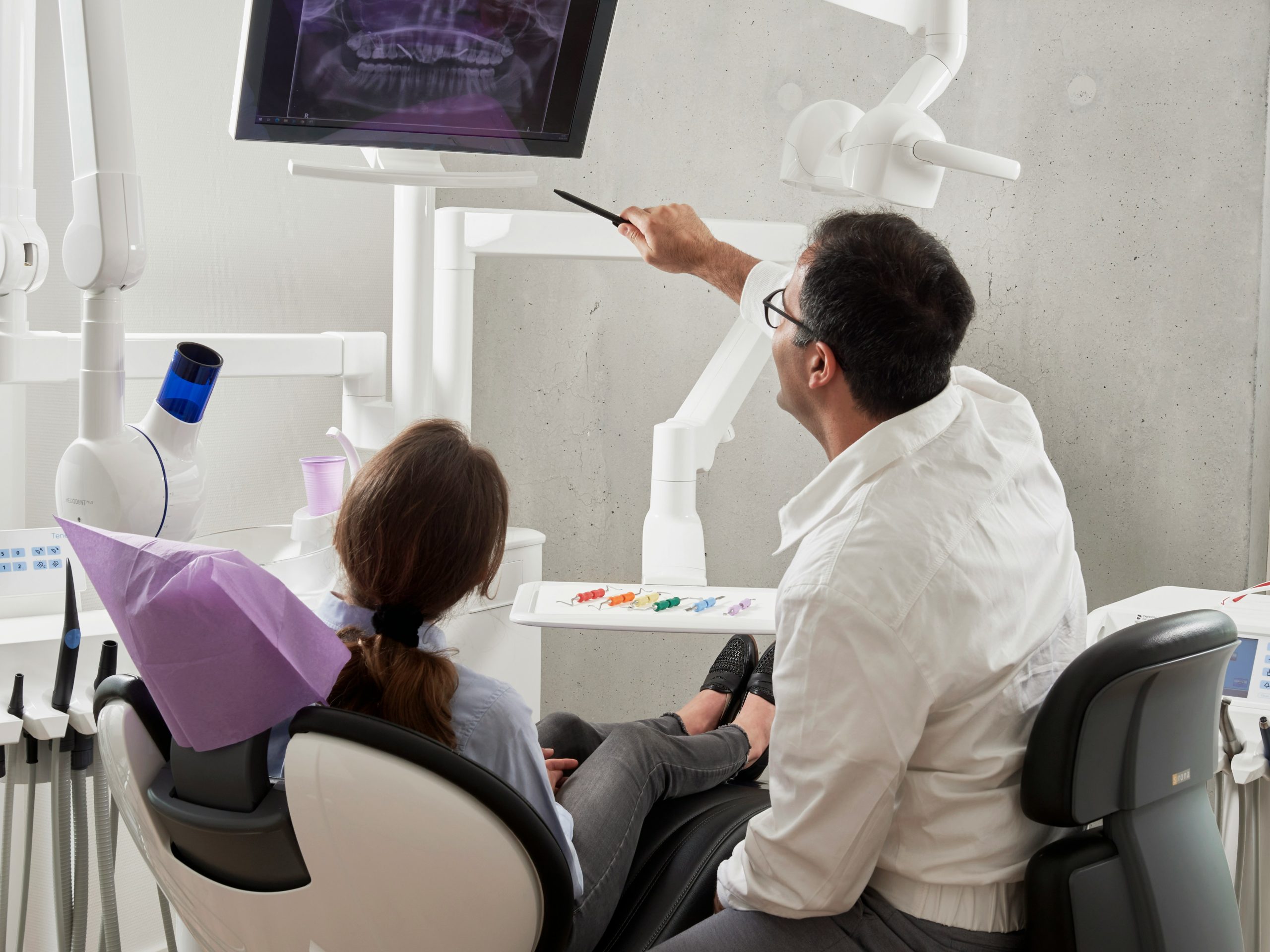 compassionate oral surgeon reviewing x-rays with patient