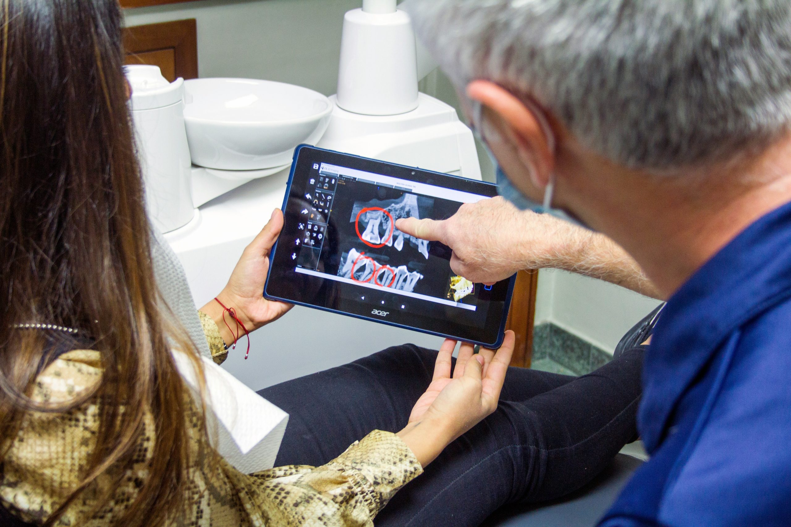 consultation for facial trauma restoration in hampton roads - doctor reviewing x-rays with patient